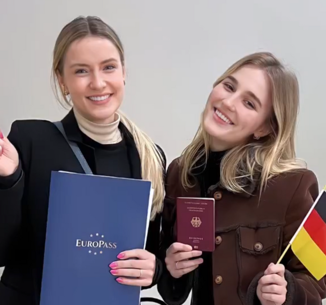 Cliente segurando o passaporte alemão bordô recém-entregue com a Pasta Europass